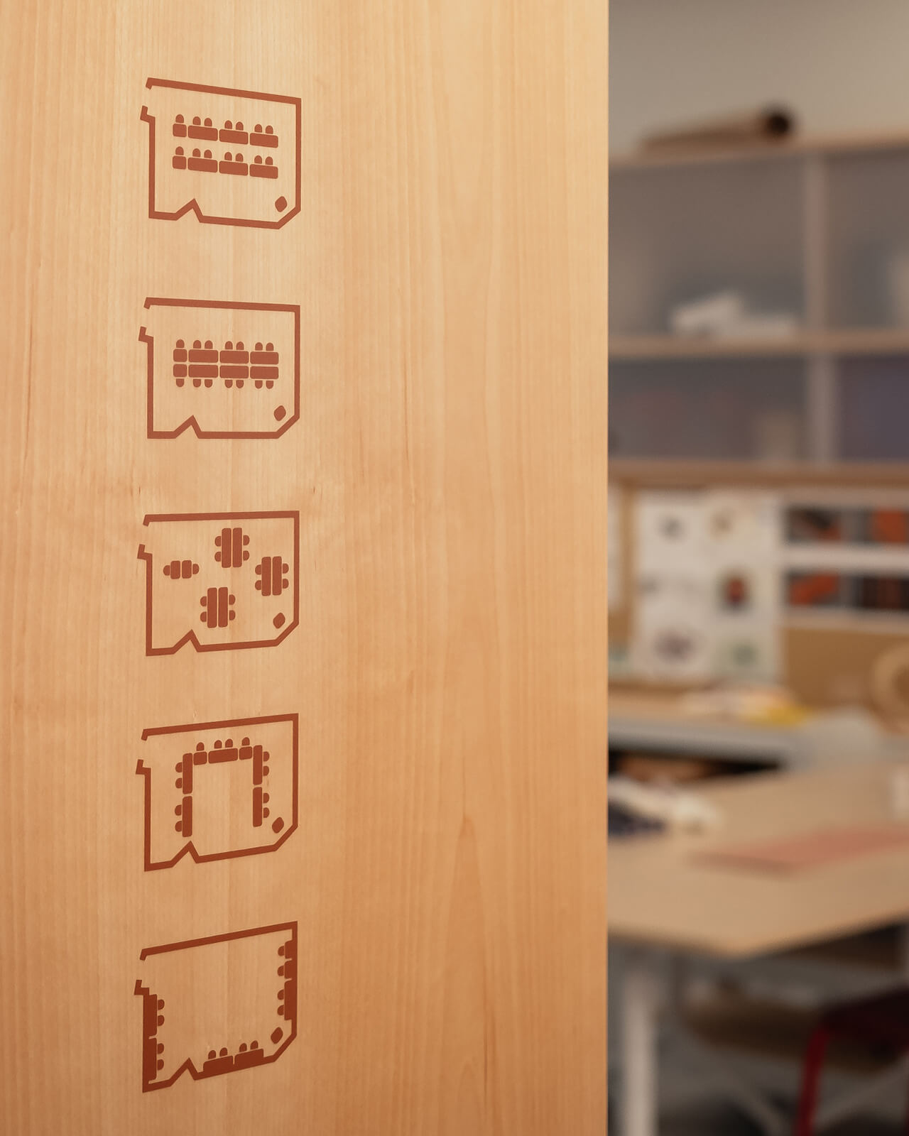 Illustration of different room layouts represented by icons on a wooden door panel.
